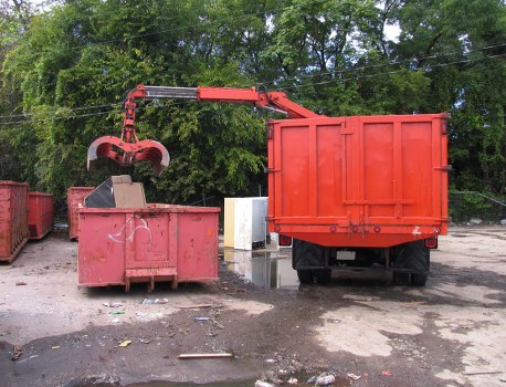 Workers loading medium-sized commercial load outside shop